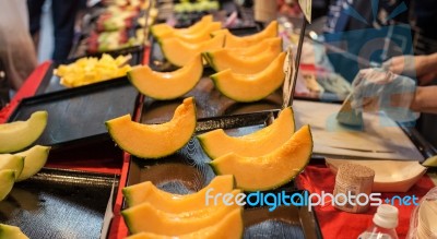 Cutting Japanese Melon Stock Photo