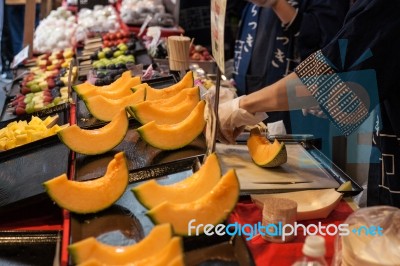 Cutting Japanese Melon Stock Photo