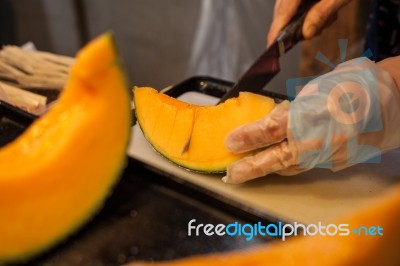 Cutting Japanese Melon Stock Photo