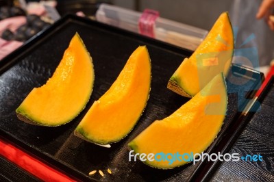 Cutting Japanese Melon Stock Photo