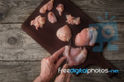 Cutting Raw Chicken Fillet On The Wooden Board Top View Stock Photo