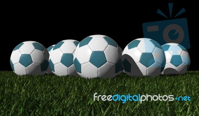 Cyan Soccer Balls On A Green Grass Stock Image