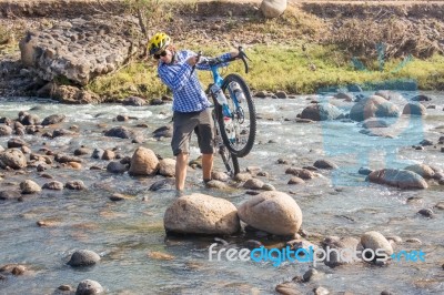 Cyclist Crossing Rio Humuya In Honduras Stock Photo