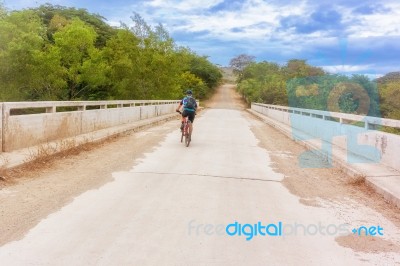 Cyclist On Countryside Road Near Alauca In Honduras Stock Photo