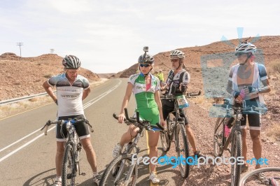 Cyclists On The Road Near Seeheim In Namibia Stock Photo