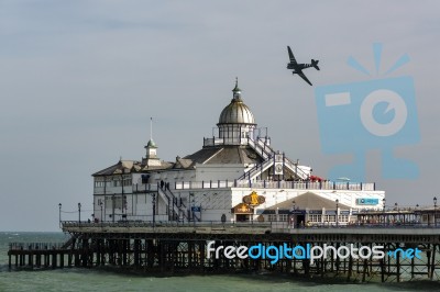 Dakota Flying Over Eastbourne Pier Stock Photo