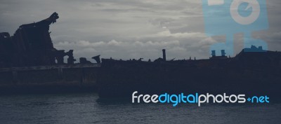 Dark And Gloomy Effect On The Shipwrecks At Tangalooma Island Stock Photo