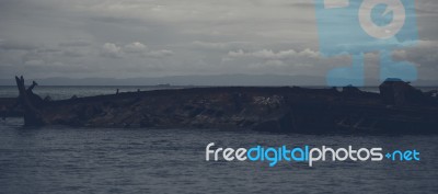 Dark And Gloomy Effect On The Shipwrecks At Tangalooma Island Stock Photo