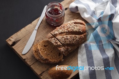 Dark Multigrain Bread Whole Grain And Jam Fresh Baked On Rustic Closeup Stock Photo