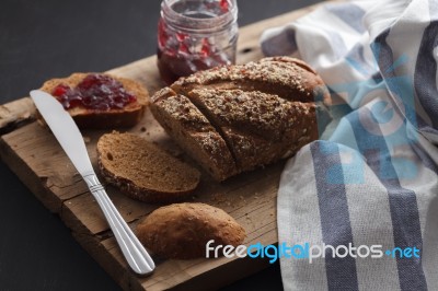 Dark Multigrain Bread Whole Grain And Jam Fresh Baked On Rustic Closeup Stock Photo