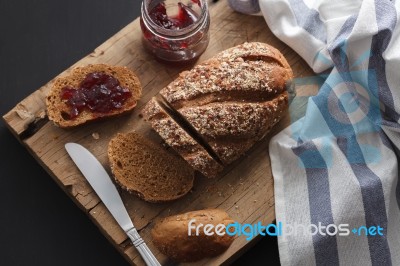 Dark Multigrain Bread Whole Grain And Jam Fresh Baked On Rustic Closeup Stock Photo