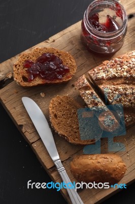 Dark Multigrain Bread Whole Grain And Jam Fresh Baked On Rustic Closeup Stock Photo