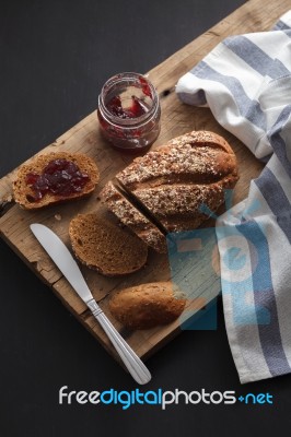 Dark Multigrain Bread Whole Grain And Jam Fresh Baked On Rustic Closeup Stock Photo