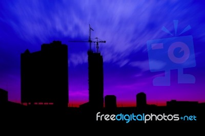 Dark Twilight And Silhouette Construction City With Crane On Top Building Stock Photo