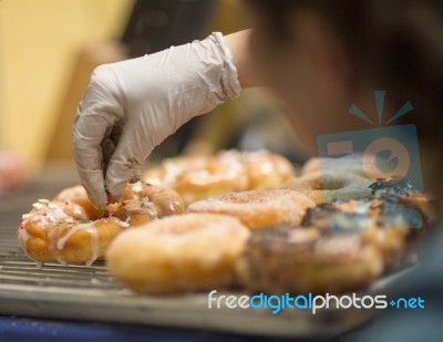 Decorating The Donuts Stock Photo