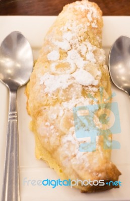 Delicious Almond Croissant Sprinkled With Icing Sugar Stock Photo