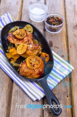 Delicious Baked Chicken Thighs With Lemon Slices, Onion And Zucchini Stock Photo