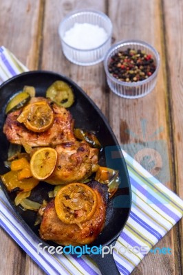 Delicious Baked Chicken Thighs With Lemon Slices, Onion And Zucchini Stock Photo