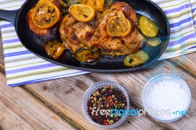 Delicious Baked Chicken Thighs With Lemon Slices, Onion And Zucchini Stock Photo