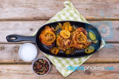 Delicious Baked Chicken Thighs With Lemon Slices, Onion And Zucchini Stock Photo