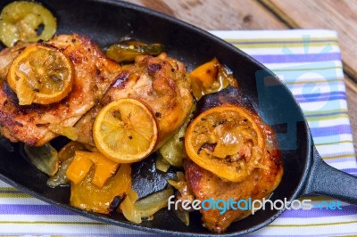 Delicious Baked Chicken Thighs With Lemon Slices, Onion And Zucchini Stock Photo