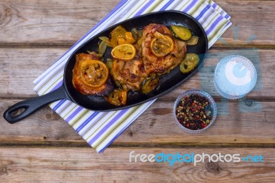 Delicious Baked Chicken Thighs With Lemon Slices, Onion And Zucchini Stock Photo