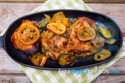 Delicious Baked Chicken Thighs With Lemon Slices, Onion And Zucchini Stock Photo