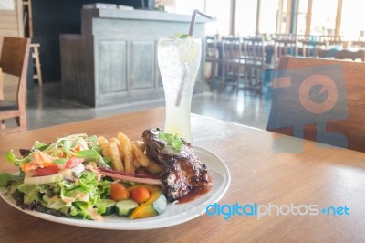 Delicious Barbecued Ribs And Lemon Soda Drink Stock Photo