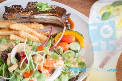 Delicious Barbecued Ribs And Lemon Soda Drink Stock Photo