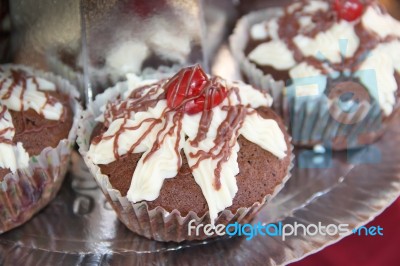 Delicious Cupcakes And Muffins With Chocolate And Cherries Stock Photo