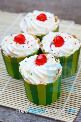 Delicious Cupcakes On The Wooden Floor Stock Photo