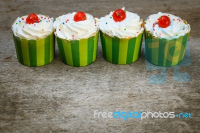 Delicious Cupcakes On The Wooden Floor Stock Photo