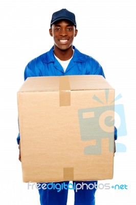 Delivery Boy Holding Cardboard Box Stock Photo