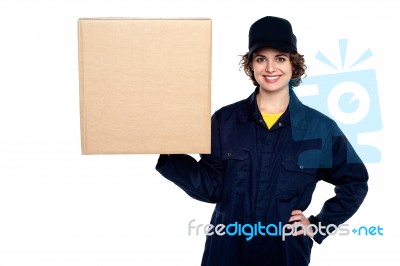 Delivery Woman Balancing A Sealed Carton Stock Photo