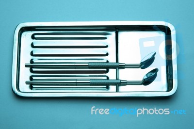 Dental Mirror On Plate Stock Photo