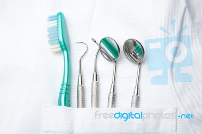 Dental Tools In Dentist Pocket Stock Photo