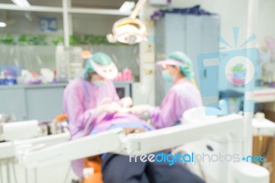 Dentist And Dental Assistants In Hospital ( Blurry Dental Background ) In Thailand Stock Photo