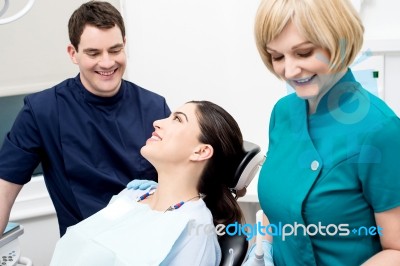 Dentist And Patient Under Discussion Stock Photo