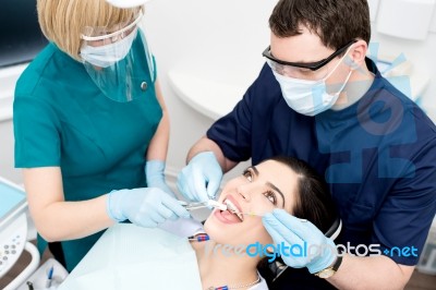 Dentist Cleaning A Woman Teeth Stock Photo