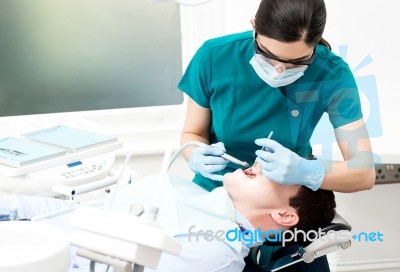 Dentist Cleaning Patient Teeth Stock Photo