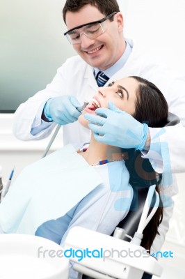 Dentist Examine On A Female Patient Stock Photo