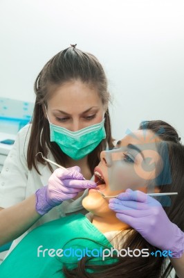 Dentist Examining A Patient's Teeth In The Dentist Stock Photo