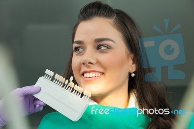 Dentist Examining A Patient's Teeth In The Dentist Stock Photo