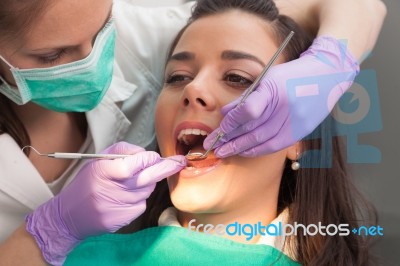 Dentist Examining A Patient's Teeth In The Dentist Stock Photo