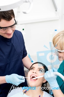 Dentist Examining A Woman Teeth Stock Photo