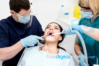 Dentist Examining A Woman Teeth Stock Photo