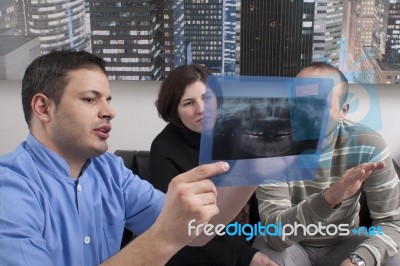 Dentist Explaining Dental Xray To Patient Stock Photo