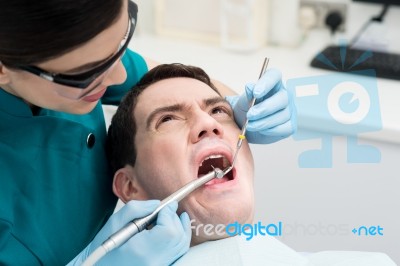 Dentist Treat A Man Teeth Stock Photo