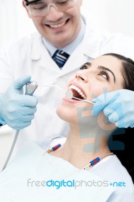 Dentist Treating His Patient Stock Photo