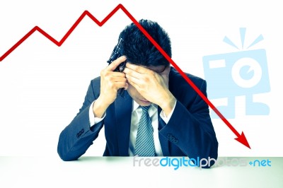 Depressed Businessman Holding A Gun Behind Bad Stock Market Char… Stock Photo